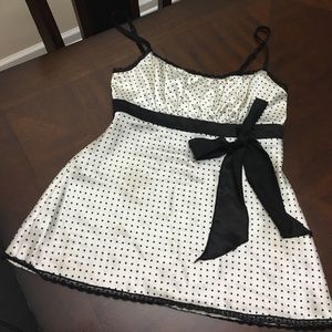 White with small black poker dots and a black bow